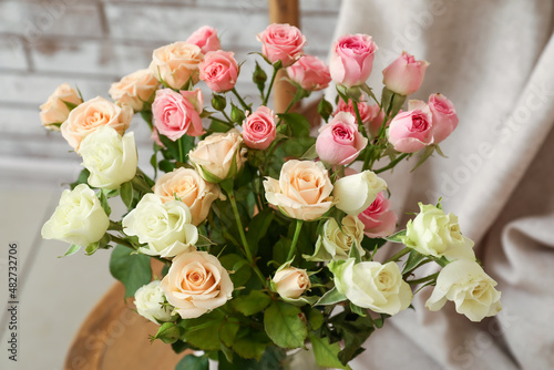 Bouquet of beautiful roses on chair