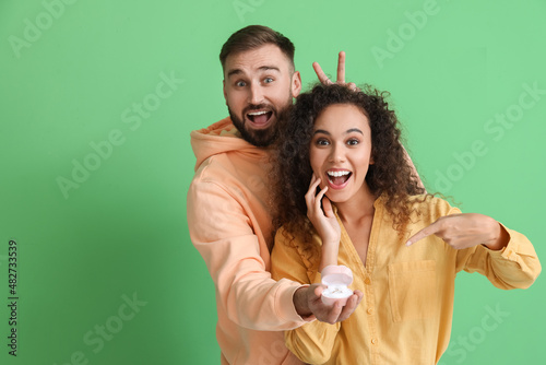 Funny young engaged couple ...
