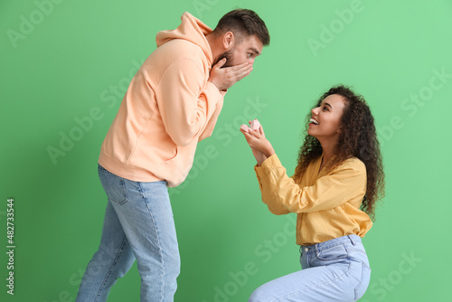 Young woman proposing to he...