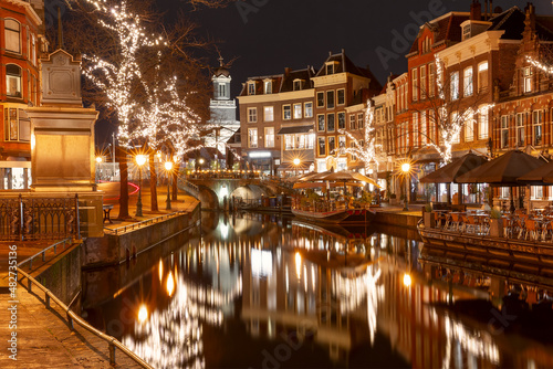 Night Leiden canal Oude Rijn in Christmas illumination, South Holland, Netherlands.
