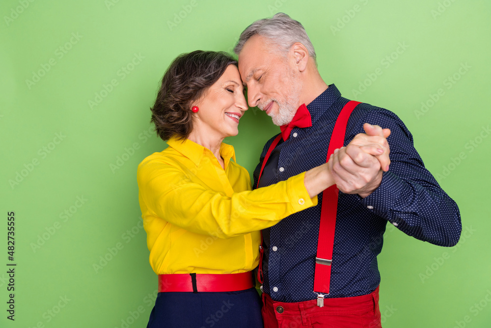 Fototapeta premium Photo of two dreamy idyllic people hold hands vintage discotheque isolated on green color background