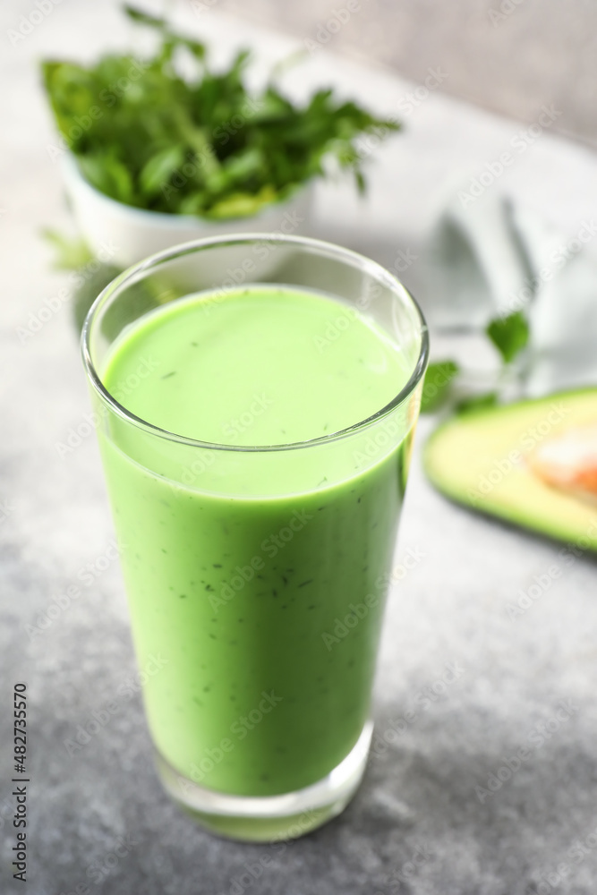 Glass of healthy green juice on table