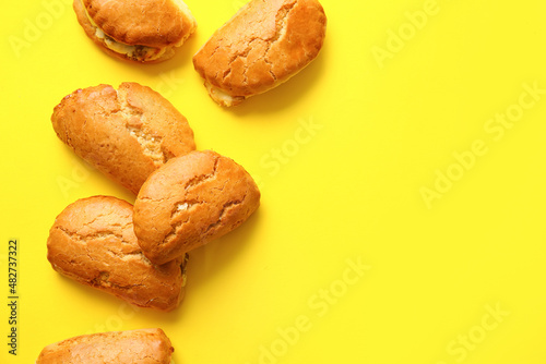 Tasty sochniki with cottage cheese on yellow background photo