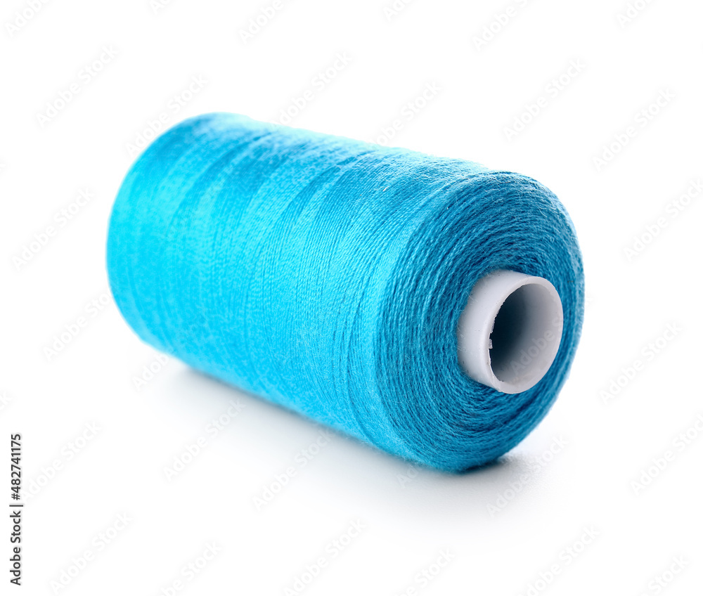 Blue sewing thread spool on white background Blue sewing thread spool on white background