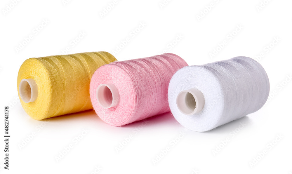 Different sewing thread spools on white background Different sewing thread spools on white background