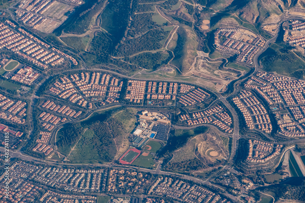 Aerial view of suburban style homes in the urban-rural divide in the foothills of Southern California.
