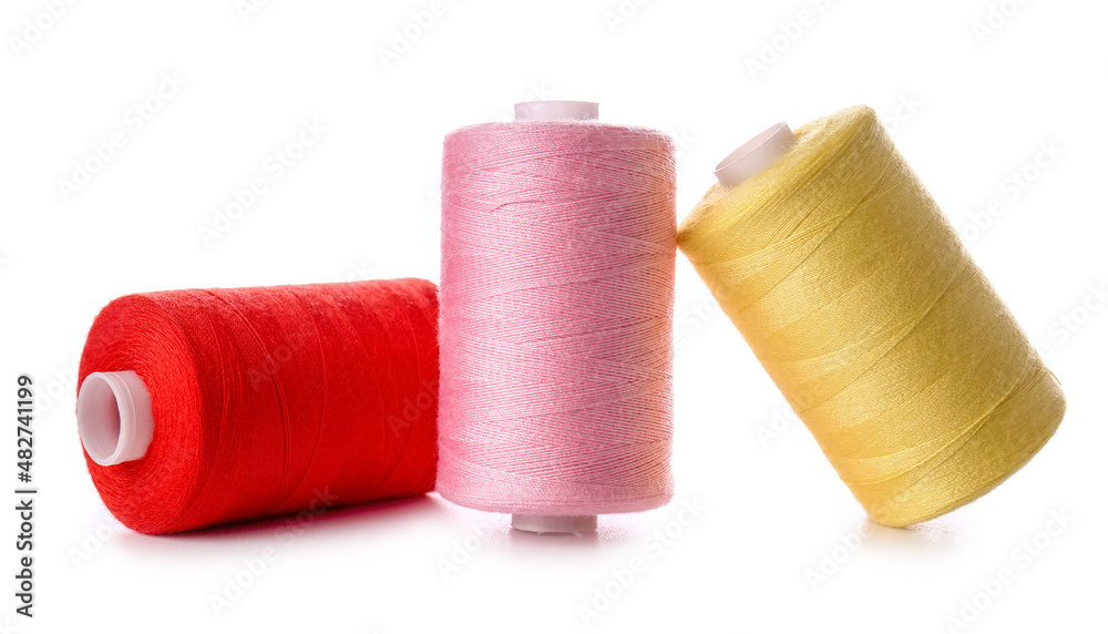 Different sewing thread spools on white background Different sewing thread spools on white background