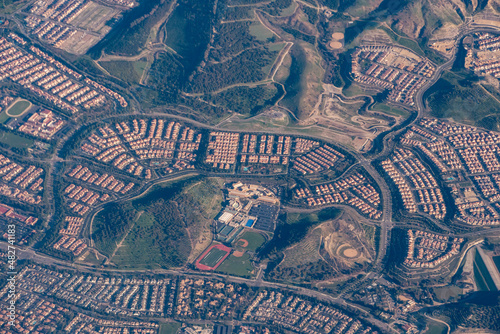 Aerial view of suburban style homes in the urban-rural divide in the foothills of Southern California.
