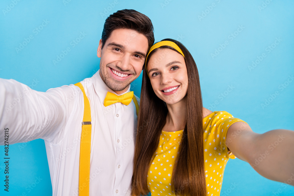 Fototapeta premium Photo of two positive friendly partners make selfie toothy smile isolated on blue color background