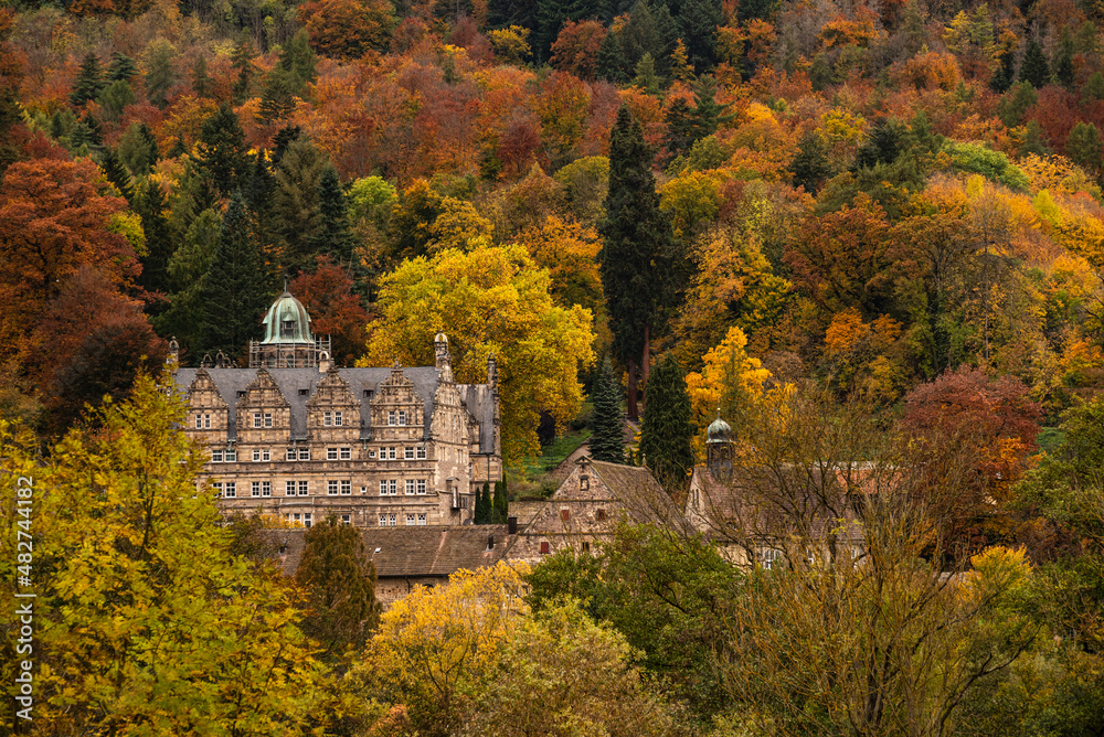 Scenic view of the picturesque Hämelschenburg Castle from the Weser Renaissance period, surrounded by colorful autumn forest, Weser Uplands, Lower Saxony, Germany