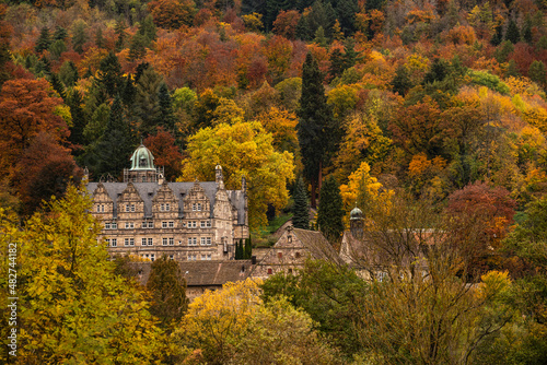 Scenic view of the picturesque Hämelschenburg Castle from the Weser Renaissance period, surrounded by colorful autumn forest, Weser Uplands, Lower Saxony, Germany