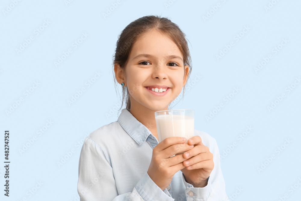 Little girl with glass of milk on color background Little girl with glass of milk on color background