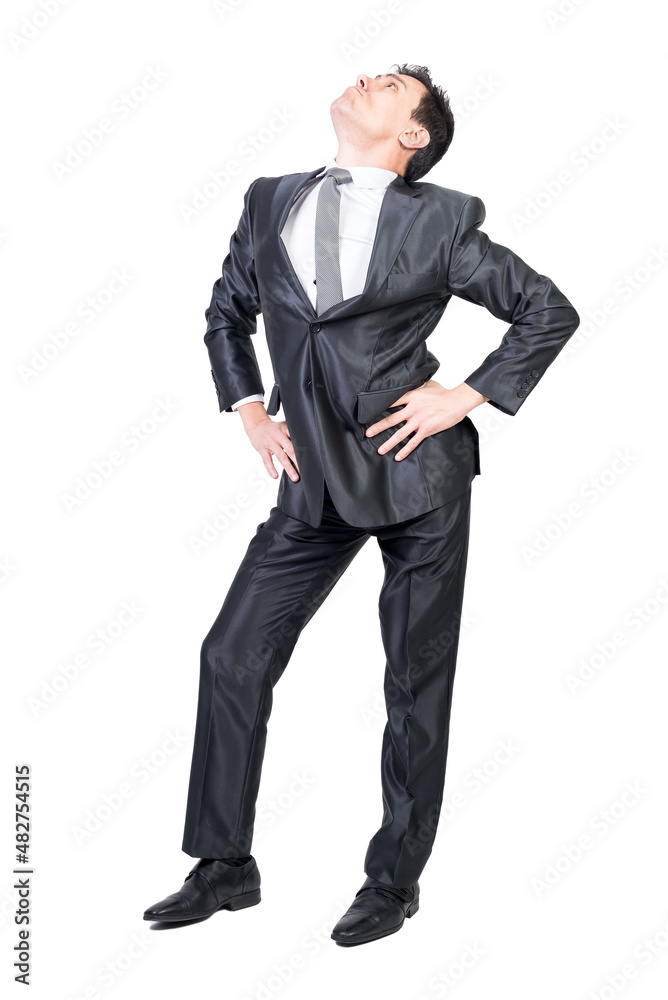 Self assured young businessman looking up in white studio Self assured young businessman looking up in white studio