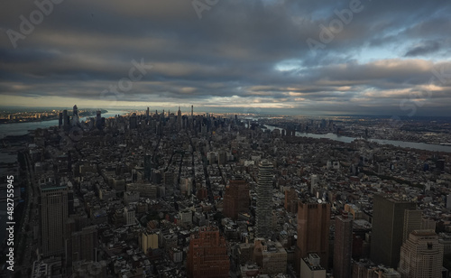 Sunset in New York, view from above. Amazing sun light over Manhattan and Hudson river during a sunset, images taken from the highest building in the city. Impressive architecture. Landmark of America © Dragoș Asaftei