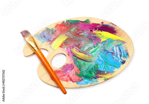 Wooden artist's palette with mixed paints and brush isolated on white