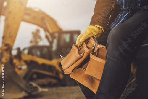 Construction Worker with Tools Belt in His Hands