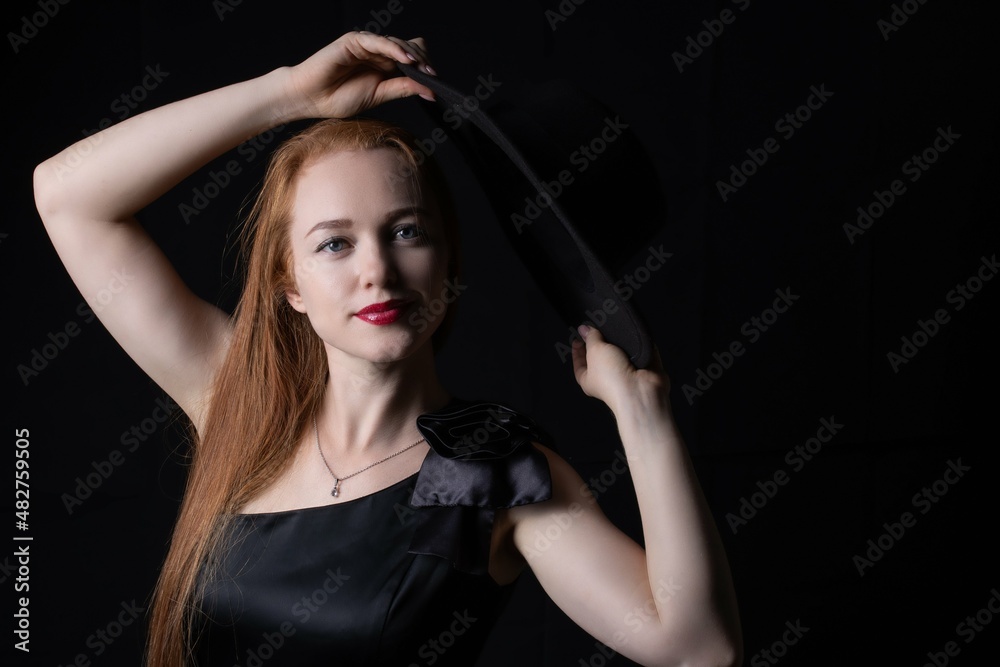 portrait of a girl with long hair, wearing a hat, on a black background portrait of a girl with long hair, wearing a hat, on a black background