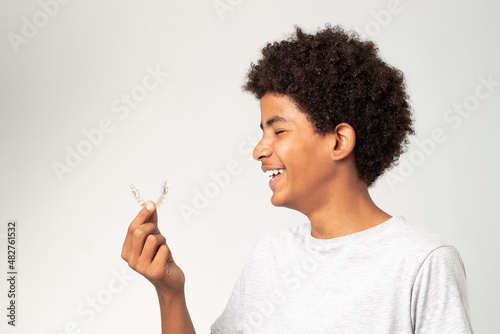 boy teenager afro smiling with dental aligners isolated