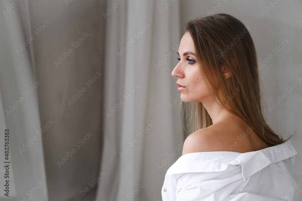 Pretty gentle Caucasian woman happy in white shirt. Daring fashion style portrait of decisive sensual female. Confident relaxed free girl, sunny morning room. Freshness, beauty, natural skin Pretty gentle Caucasian woman happy in white shirt. Daring fashion style portrait of decisive sensual female. Confident relaxed free girl, sunny morning room. Freshness, beauty, natural skin