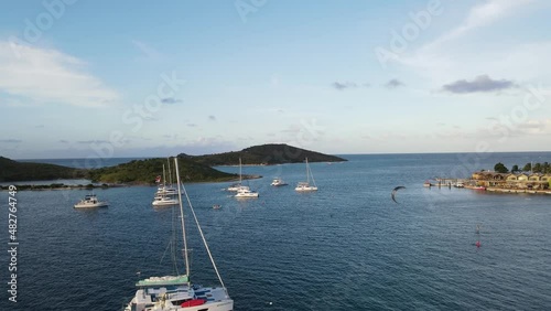 a parasailor around the yachts and Saba Rock near sunset in the beautiful British Virgin Islands photo