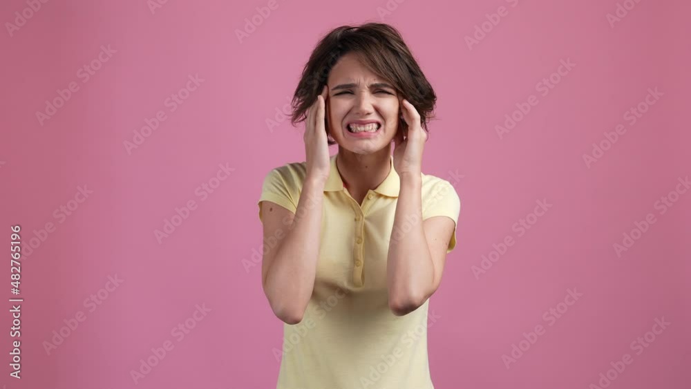 Lady touch temples hands severe headache isolated pastel color background Lady touch temples hands severe headache isolated pastel color background