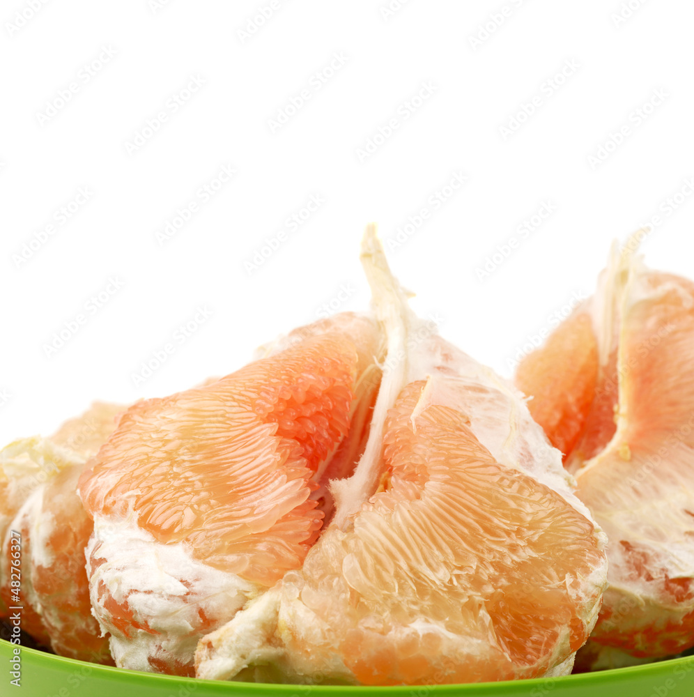 peeled pomelo pieces isolated on white background. Tasty fresh fruit eating concept.