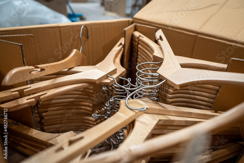 Pile of hangers arranged inside a cardboard box