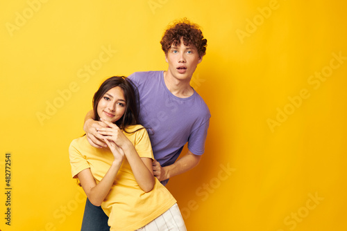 young boy and girl in colorful t-shirts posing friendship fun isolated background unaltered