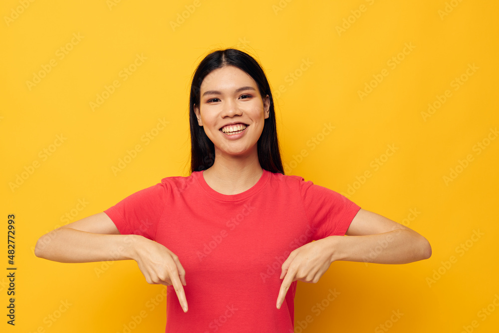 Charming young Asian woman gestures with her hands in casual clothes copy-space studio model unaltered Charming young Asian woman gestures with her hands in casual clothes copy-space studio model unaltered