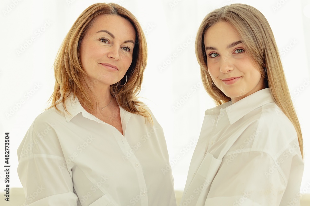 Portrait of a beautiful smiling woman and her adult daughter. Positive blonde Caucasian ethnicity. Mother's Day concept Portrait of a beautiful smiling woman and her adult daughter. Positive blonde Caucasian ethnicity. Mother's Day concept