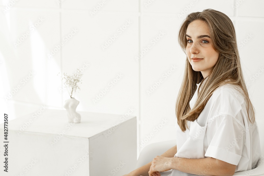 Portrait of a pretty cute young girl. Beautiful positive girl in a white cotton shirt. Copy space Portrait of a pretty cute young girl. Beautiful positive girl in a white cotton shirt. Copy space