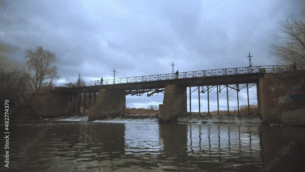 Hydroelectric dam with flowing water through gate. Clear stream calmly running by stones and good sluice made of wood. Nothing but a hydroelectric Hydroelectric dam with flowing water through gate. Clear stream calmly running by stones and good sluice made of wood. Nothing but a hydroelectric