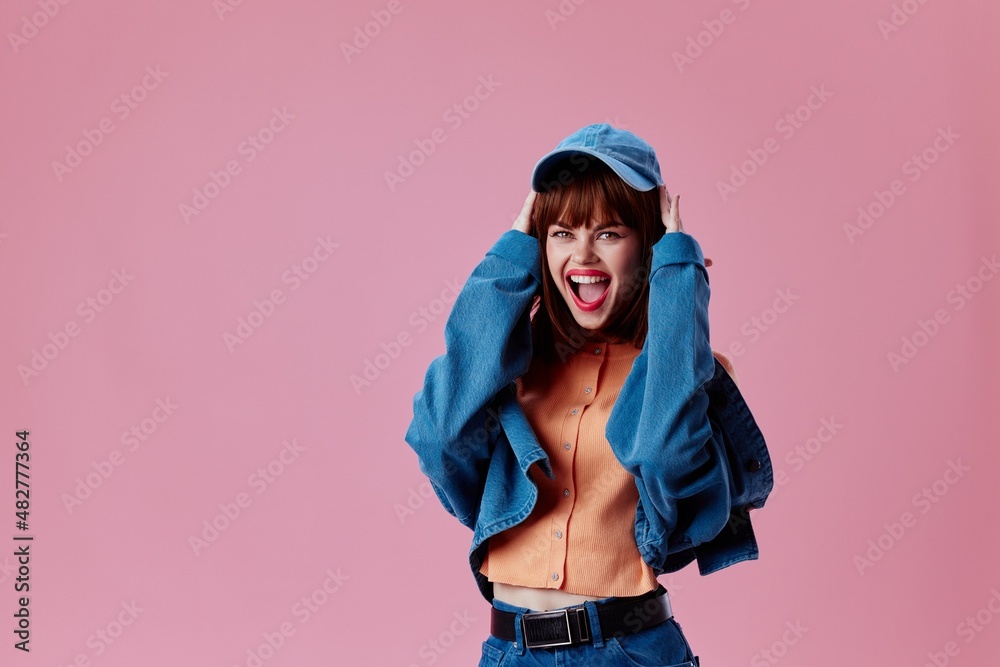 Portrait of a charming lady denim clothing fashion posing cap pink background unaltered Portrait of a charming lady denim clothing fashion posing cap pink background unaltered