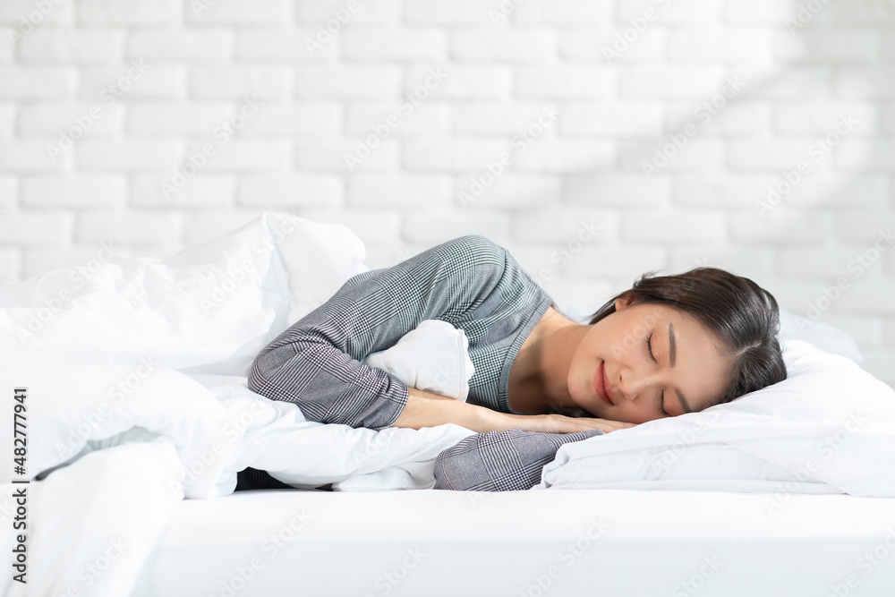 Beautiful Attractive Asian woman sleep and sweet dream lying on bed in cozy bedroom in the morning feeling so relax and comfortable.Healthy Young female sleep with bedtime at home.Healthcare Concept Beautiful Attractive Asian woman sleep and sweet dream lying on bed in cozy bedroom in the morning feeling so relax and comfortable.Healthy Young female sleep with bedtime at home.Healthcare Concept
