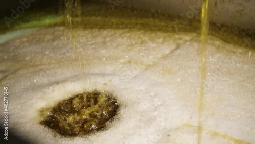 pouring liquid after pressing grapes at the winery