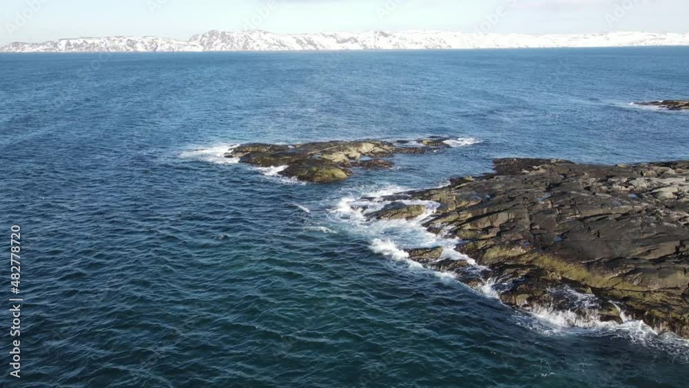 Winter aerial flight top over waves rolling on artic ocean shore with round stones, ocean waves at storm, 4k high quality drone video at winter Winter aerial flight top over waves rolling on artic ocean shore with round stones, ocean waves at storm, 4k high quality drone video at winter