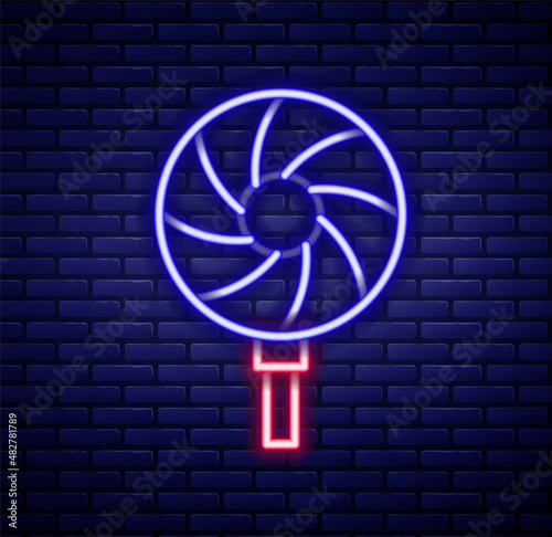 Glowing neon line Lollipop icon isolated on brick wall background. Candy sign. Food, delicious symbol. Colorful outline concept. Vector