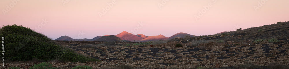 Volcanic landscape with volcanos at sunset tones