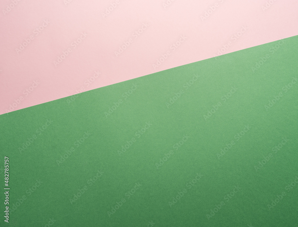 Paper background of two colors green and pink.