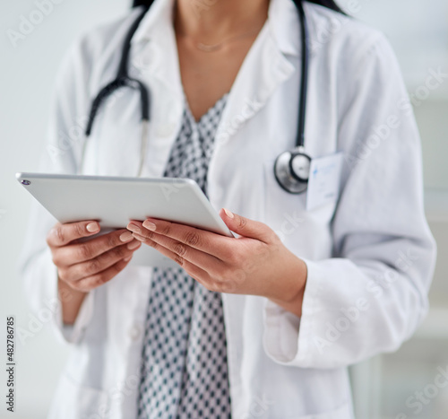 Convenient access to all things health. Cropped shot of an unrecognizable doctor using a digital tablet while working in a clinic. © Nicholas F/peopleimages.com