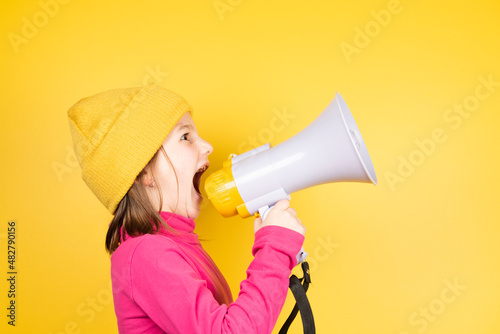 Obraz na plátně Angry little girl shouting loud on loudspeaker