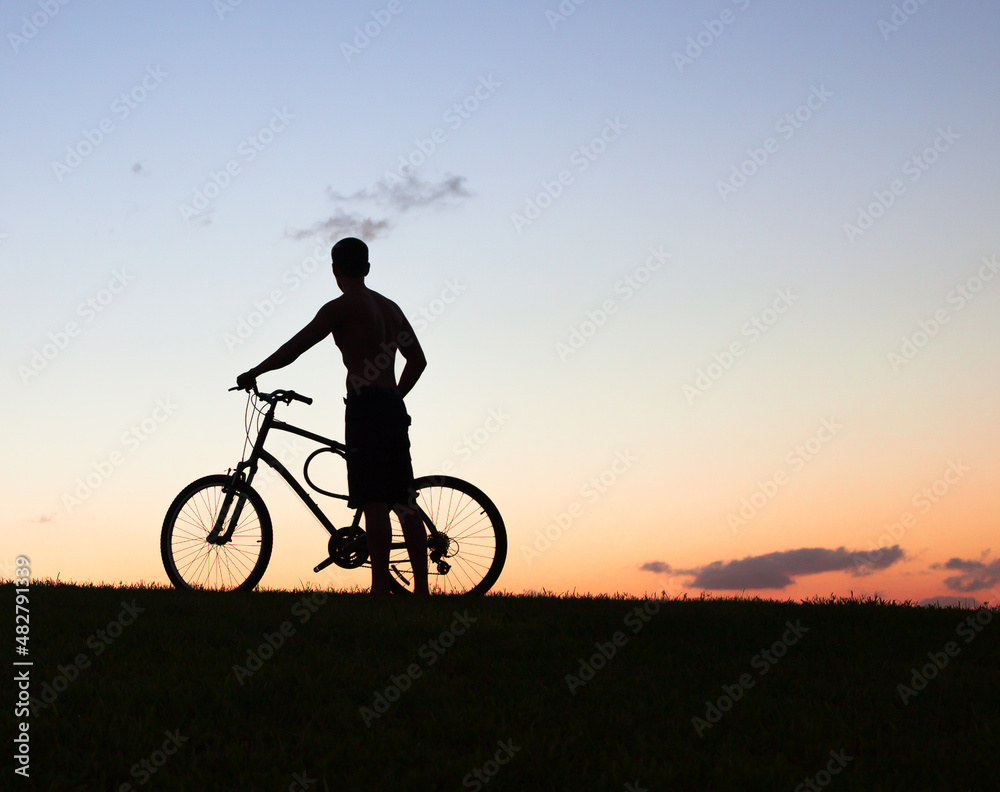 silhouette of a cyclist on the sunset