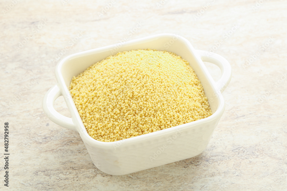 Raw couscous in the bowl Raw couscous in the bowl