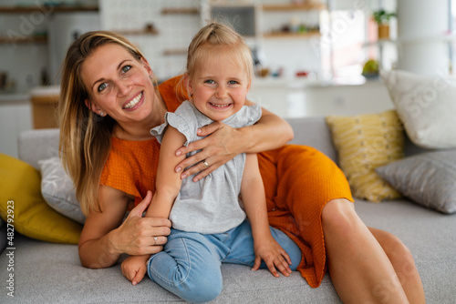 Happy loving family. Mother and her daughter child girl playing and hugging together at home