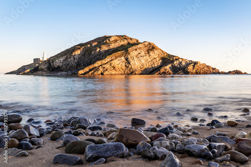 Small island near Mumbles Head and Lighthouse at sunset, Gower Peninsula, South Wales, The United Kingdom photo