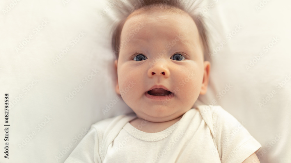 portrait of a baby with surprised funny look on her face