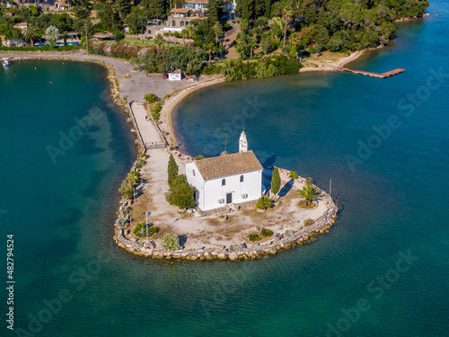 Fototapeta Naklejka Na Ścianę i Meble -  Aerial drone photo of iconic church of Ypapanti built in a small piece of land in bay of Gouvia, Corfu island, Ionian, Greece