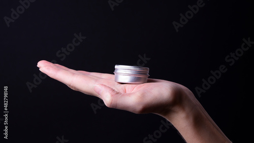 packaging of hand cream in female hands