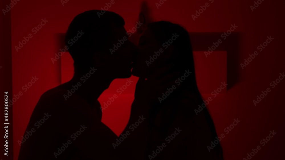 Couple kissing in the red room