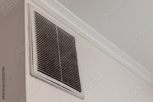 Canvas Print Dirty and dusty plastic ventilation grate fixed on concrete wall of kitchen or office room